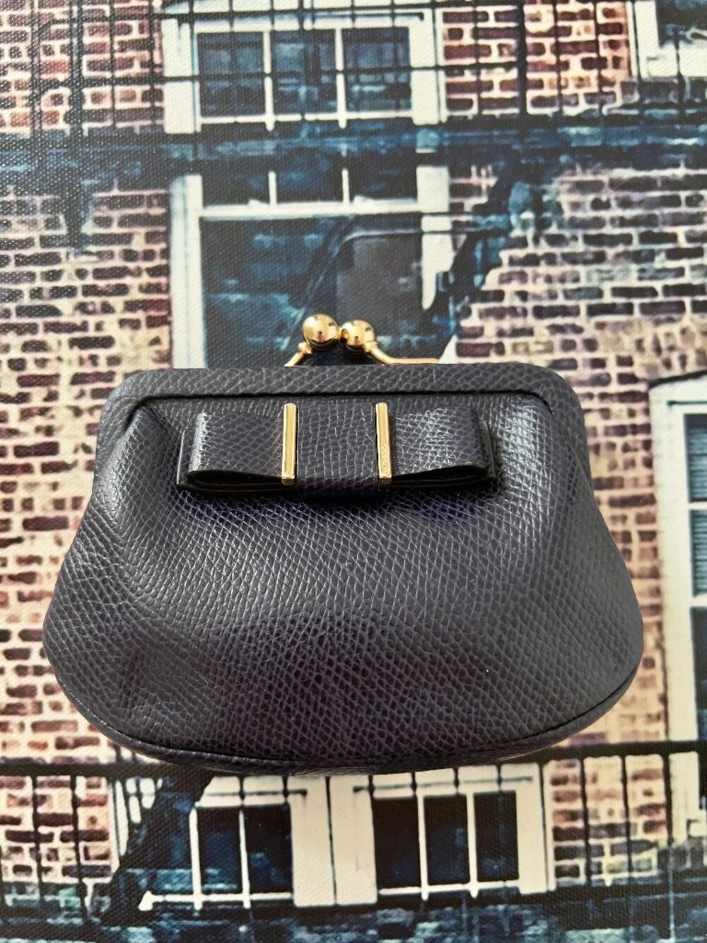 This is a Coach Darcy Bow Crossgrain Leather Kisslock Coin Purse in a dark navy